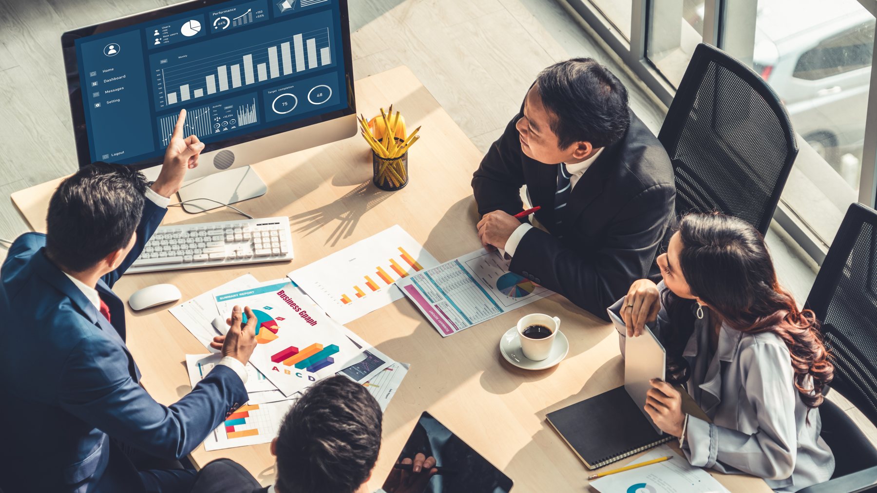 Boardroom team reviewing luxury marketing strategy and analytics