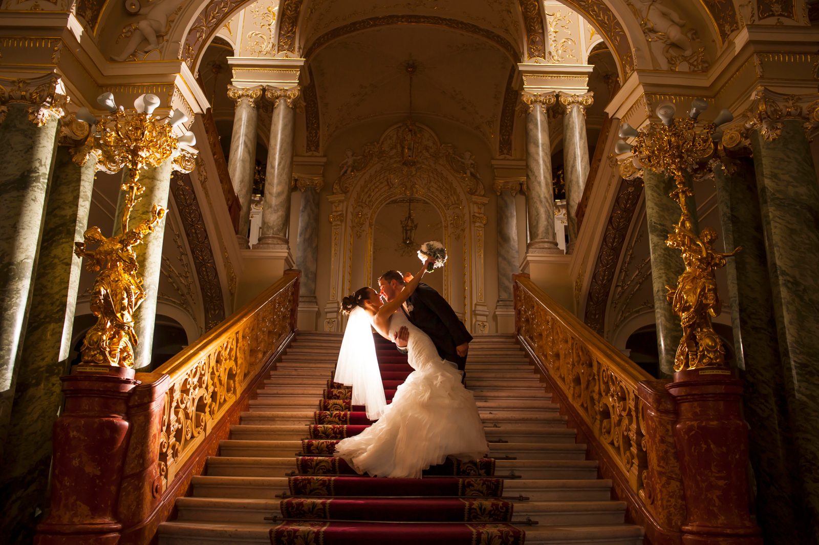 Bride and groom on a grand staircase, illustrating bridal and engagement marketing